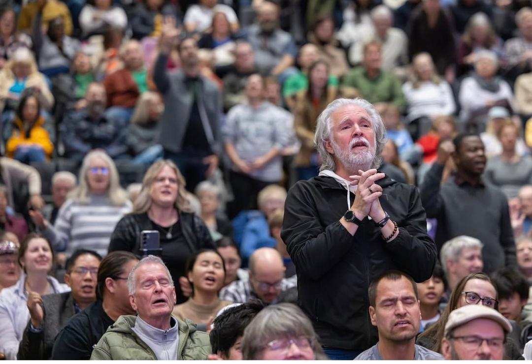 A member of the congregation praying during a Sunday gathering