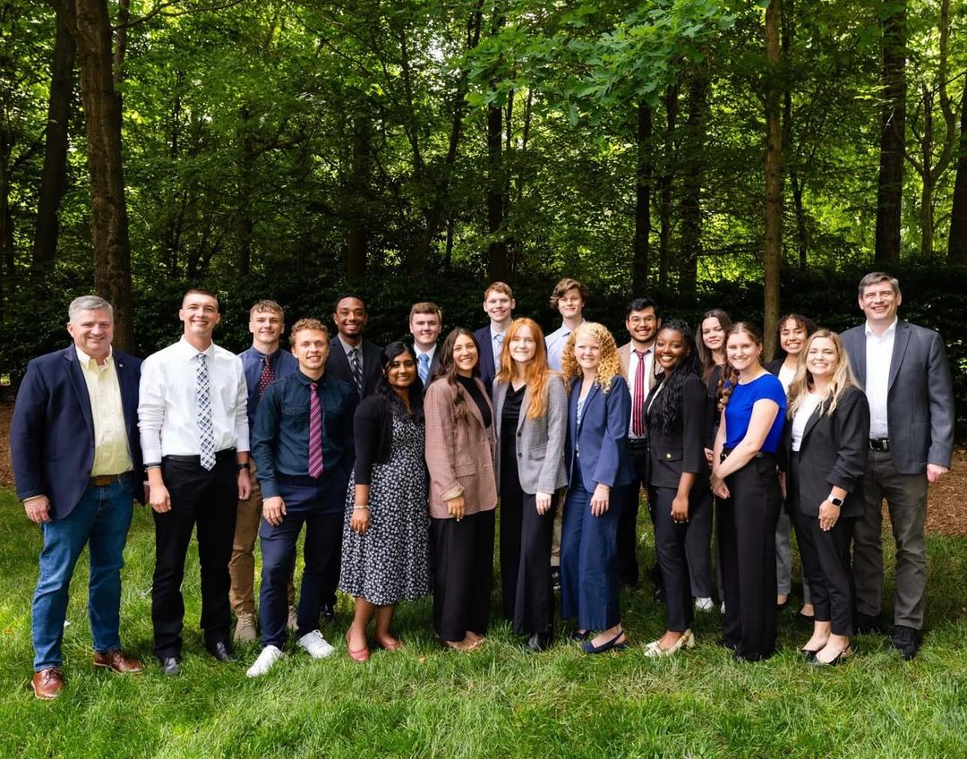 The young adults serving team standing together outdoors